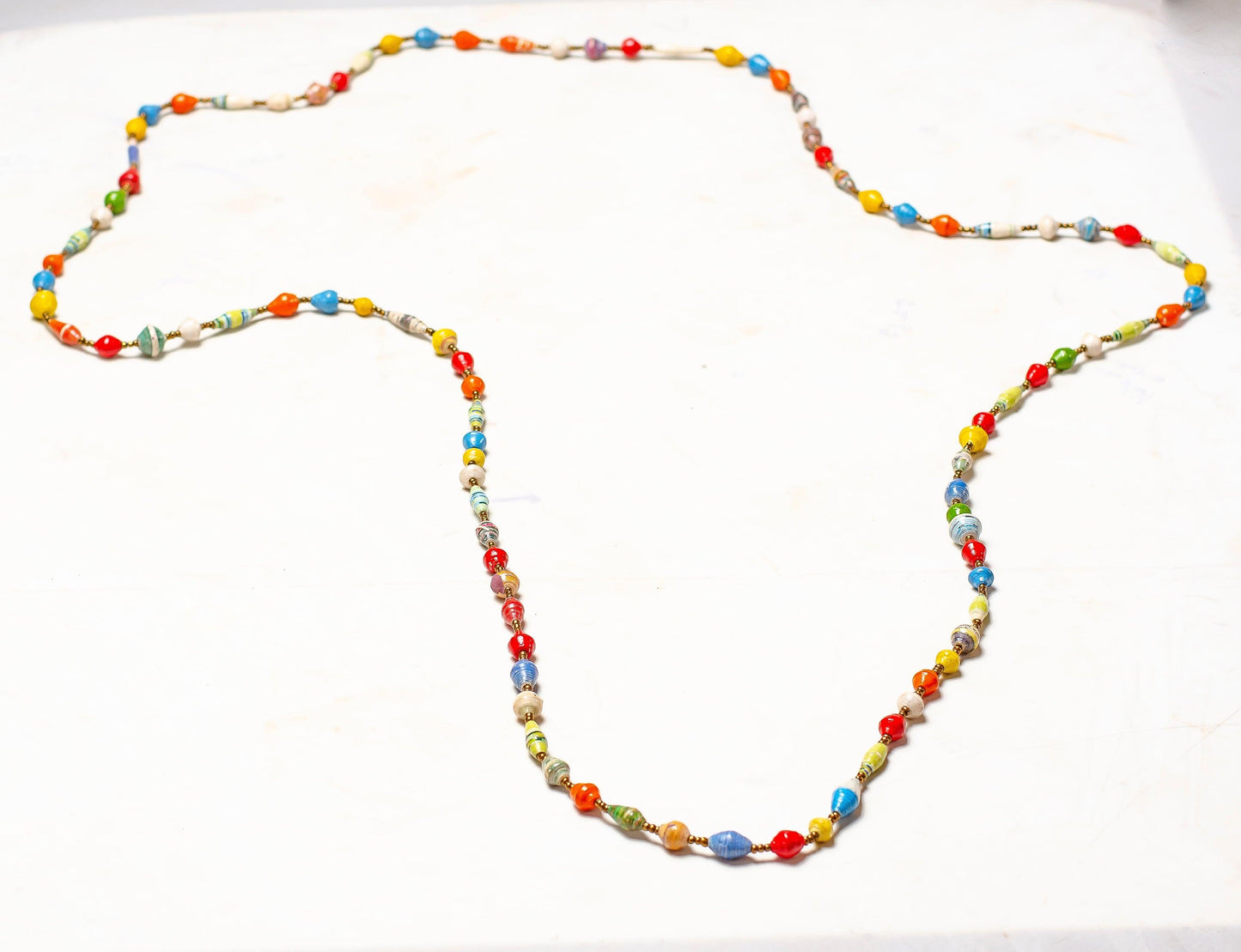 YELLOW, RED AND BROWN JACARANDA WOOD AND PLASTIC BEADS IN CHITENGE MATERIAL NECKLACE , PAIRED WITH EARRINGS AND AN AFRICAN MAIDEN PRINTED WRAPPER